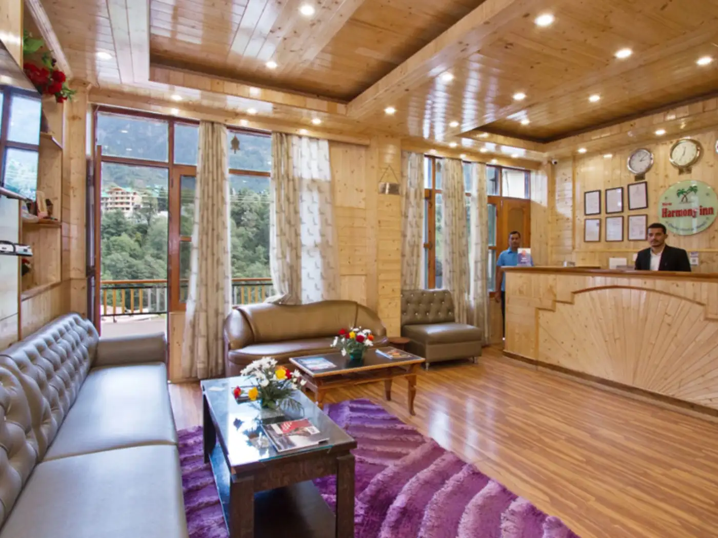 Harmony Inn lobby with wood paneling and mountain views