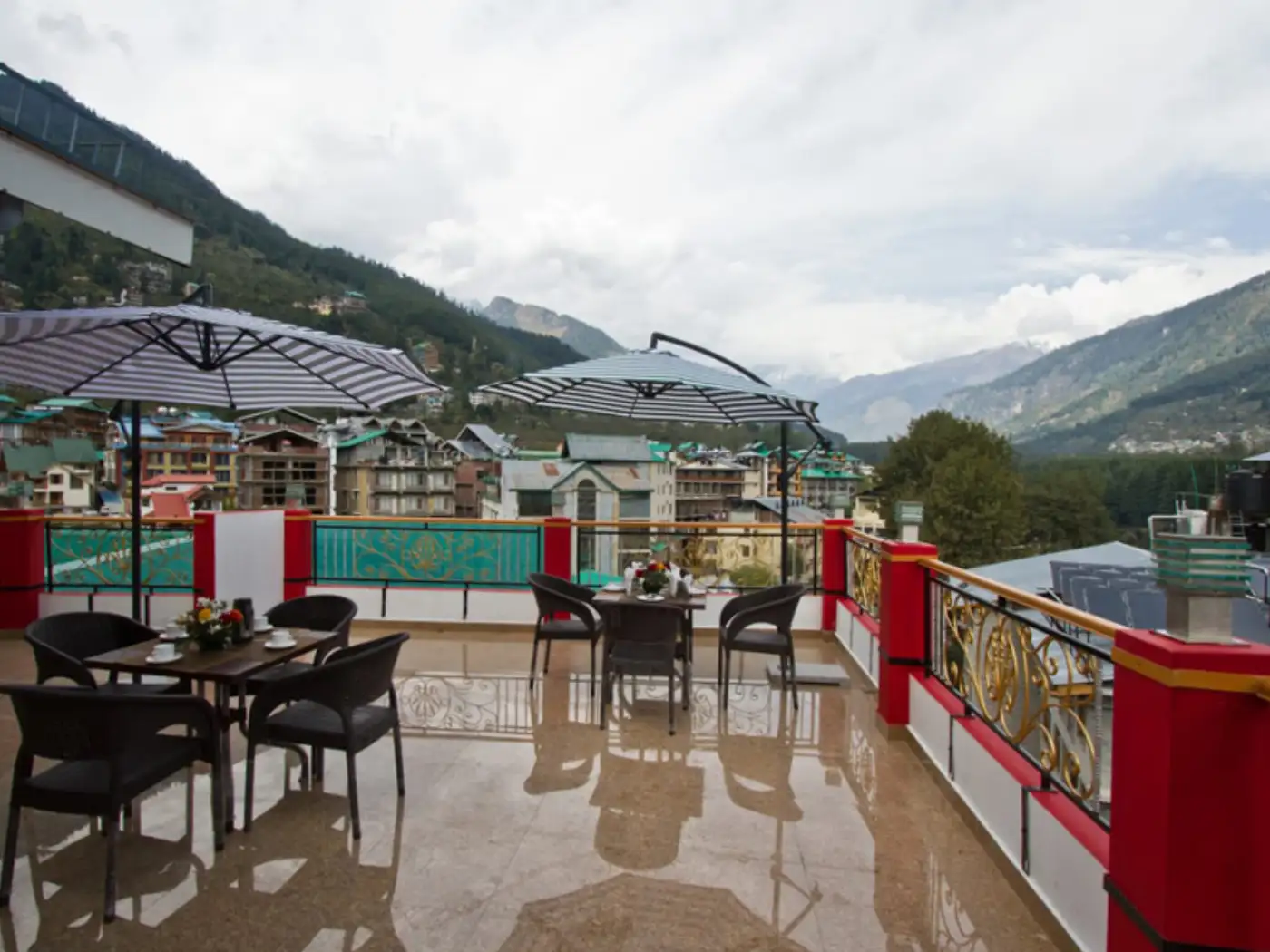 Outdoor dining terrace with mountain views at a hotel.