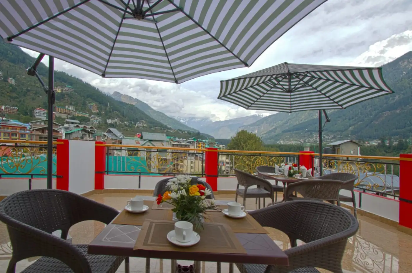 Outdoor dining terrace with mountain views at a hotel.