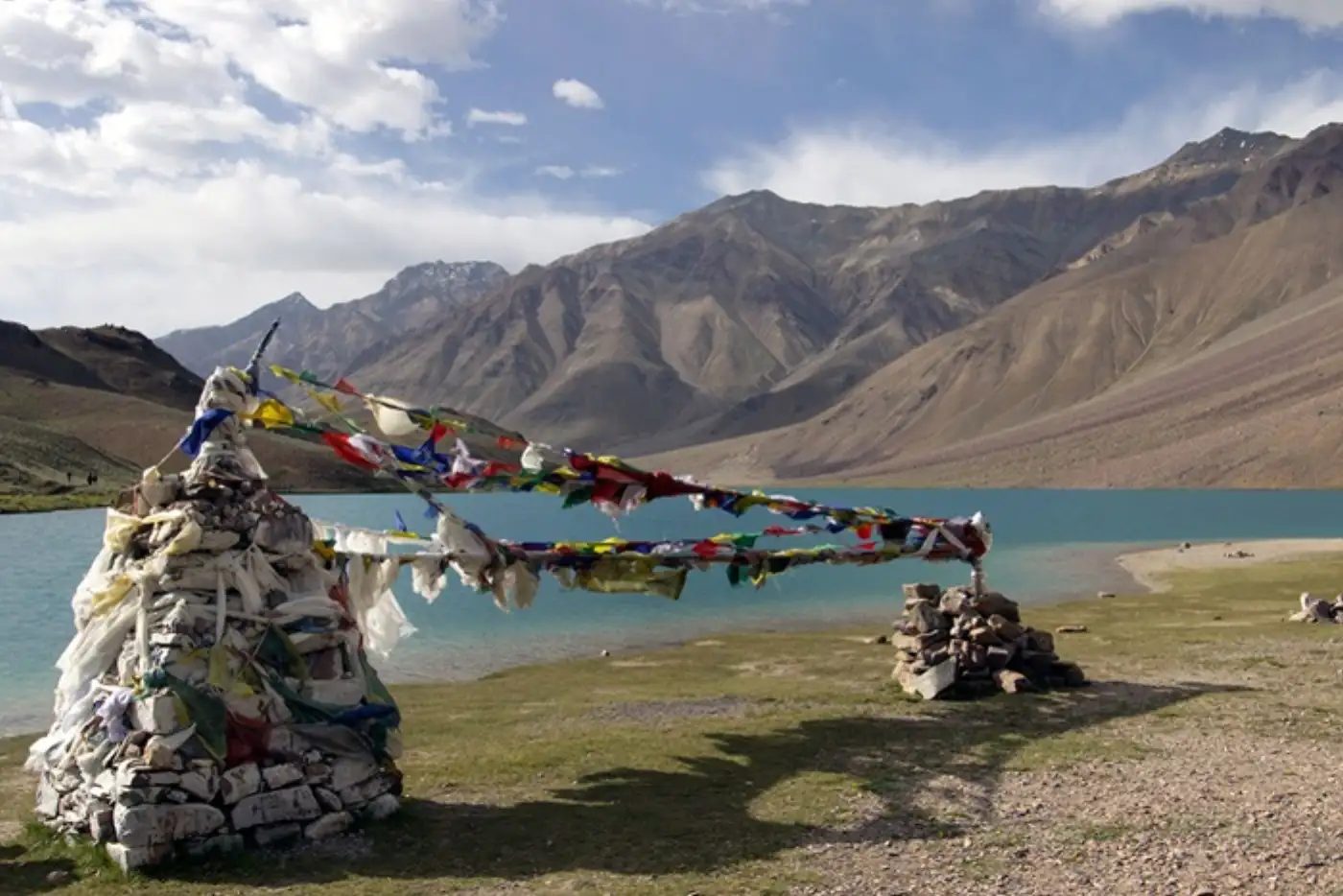 Prayer flags at Chandratal Lake, Spiti Valley. Mountain backdrop.